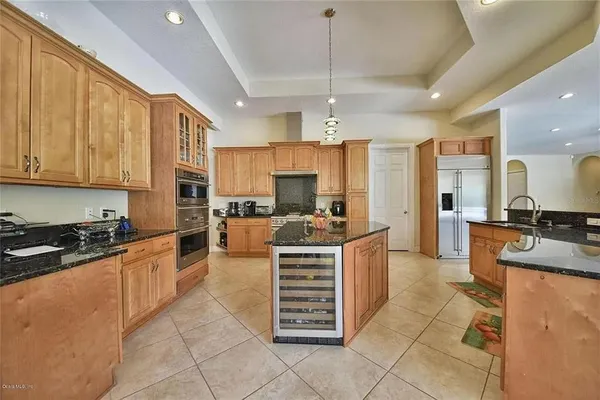 a kitchen with stainless steel appliances granite countertop a stove and cabinets