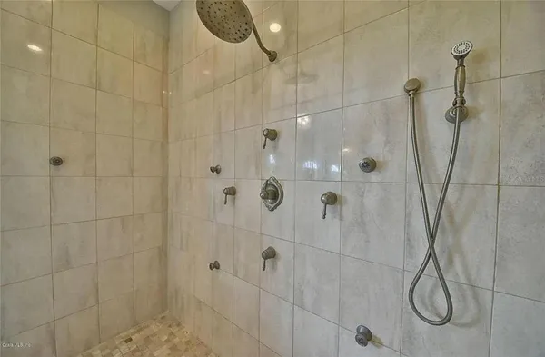 a en suite bathroom with a granite countertop sink and a mirror