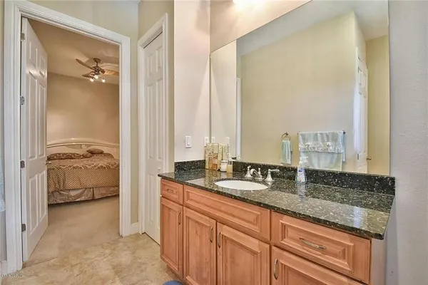 a bath room with a sink a toilet and a mirror