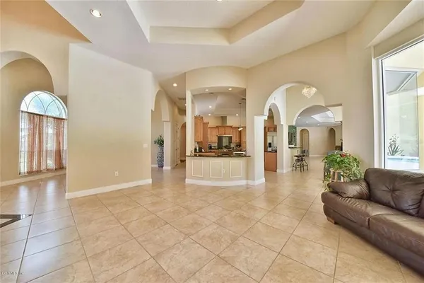 a kitchen with stainless steel appliances kitchen island granite countertop a stove top oven a sink a counter top space and cabinets