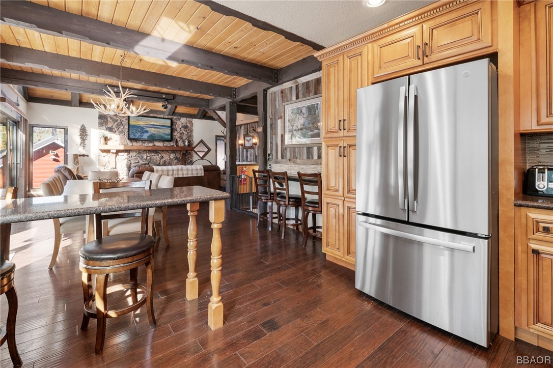 368 Pulaski Road Big Bear Lake, CA 92315 - Photo 12 of 44 a kitchen with stainless steel appliances granite countertop a refrigerator a stove and a refrigerator with wooden floor