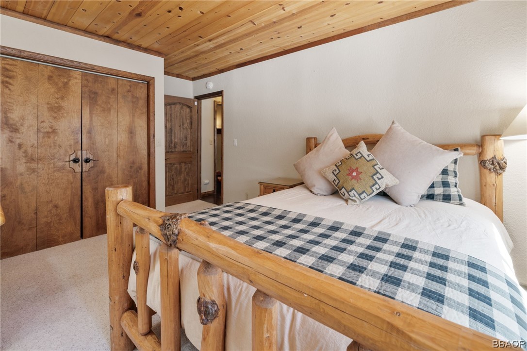 368 Pulaski Road Big Bear Lake, CA 92315 - Photo 26 of 44 a bedroom with a bed and a chandelier