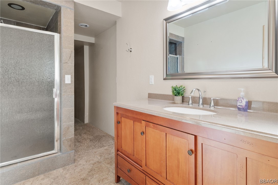 368 Pulaski Road Big Bear Lake, CA 92315 - Photo 40 of 44 a bathroom with a granite countertop sink and a mirror