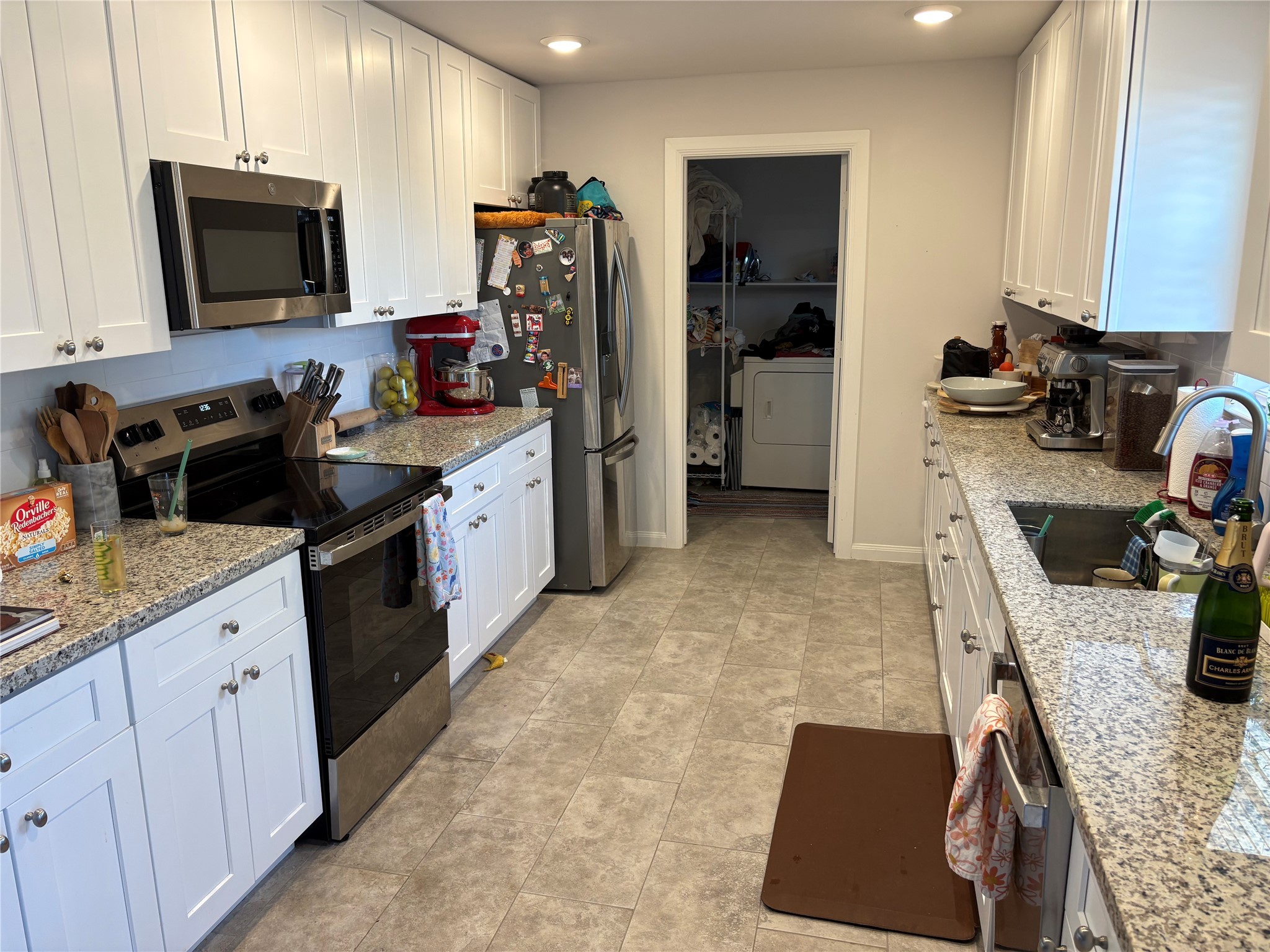 9530 Emnora Lane Houston, TX 77080 - Photo 2 of 16 a kitchen with a sink stove and refrigerator