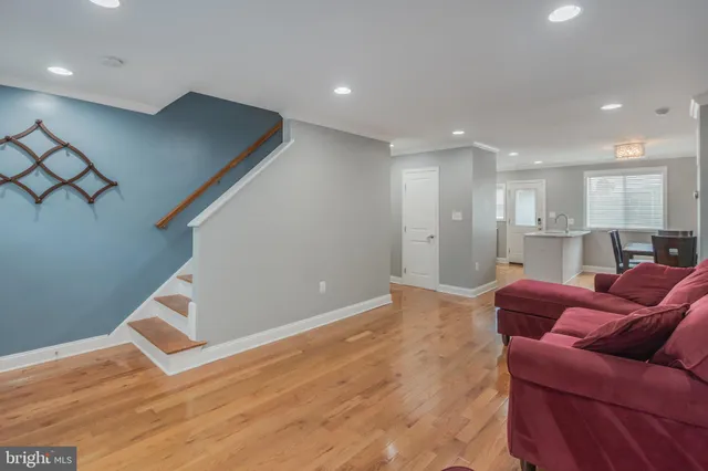 a living room with furniture and a ceiling fan