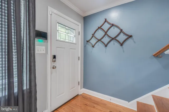 a view of a livingroom with wooden floor and a window