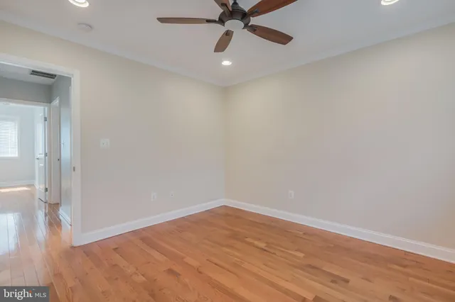 a view of an empty room with wooden floor