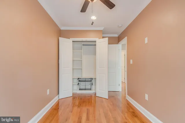 a view of empty room with wooden floor