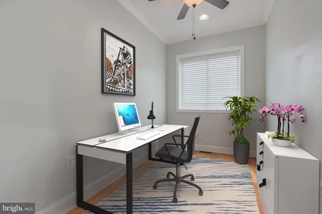 a view of a workspace with furniture and a potted plant
