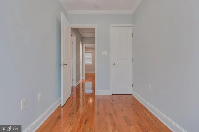 a view of a room with wooden floor and a bathroom