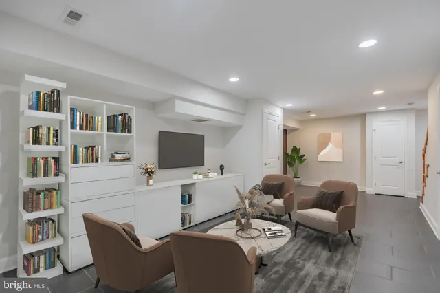 a living room with furniture a rug and a flat screen tv