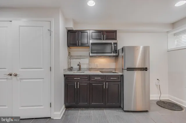 a kitchen with stainless steel appliances a refrigerator and a sink