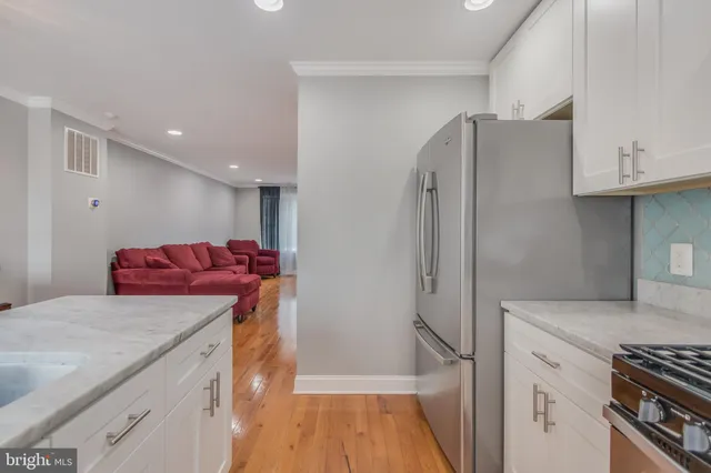 a kitchen with stainless steel appliances granite countertop a refrigerator and a stove