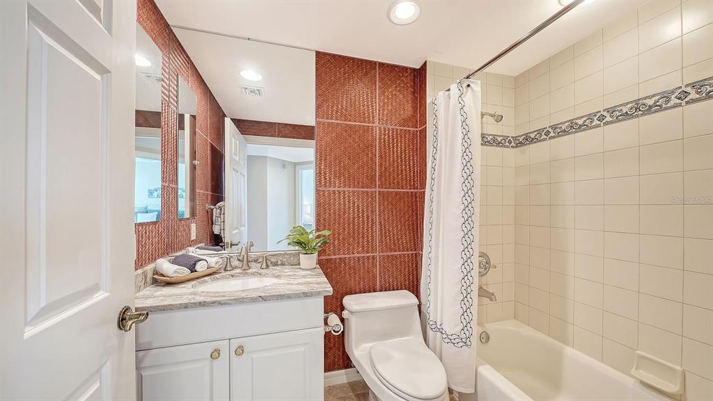 385 North Point Road, Unit 701 Osprey, FL 34229 - Photo 58 of 97 a bathroom with a granite countertop sink toilet and shower