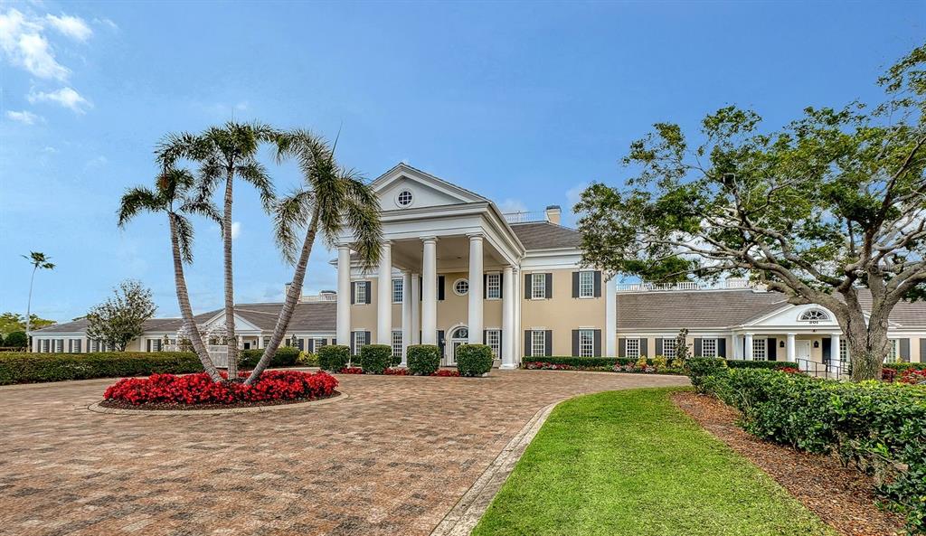 385 North Point Road, Unit 701 Osprey, FL 34229 - Photo 80 of 97 a view of a house with a yard and potted plants