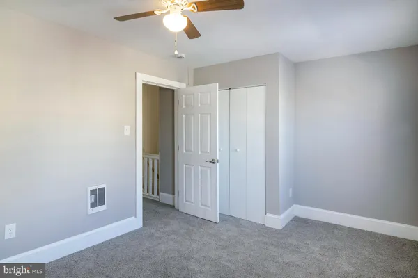 an empty room with a empty space and a ceiling fan