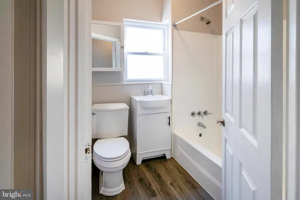a bathroom with a toilet and a bathtub