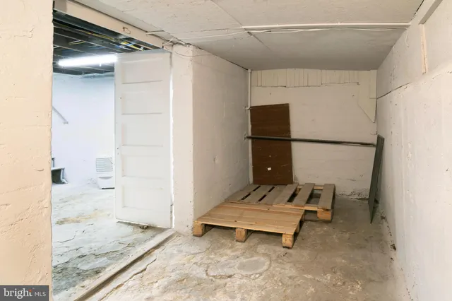 a living room with a refrigerator and a table
