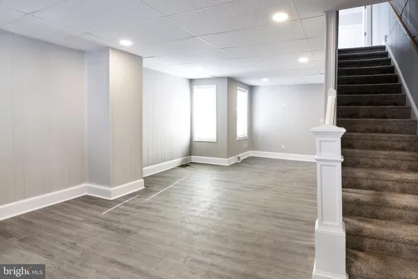 wooden floor in an empty room with stairs