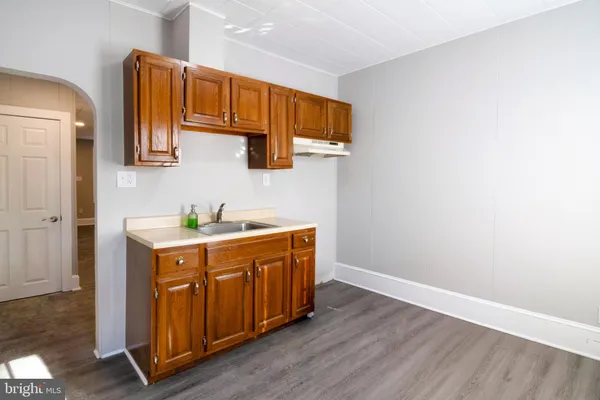 a spacious bathroom with a sink and a mirror