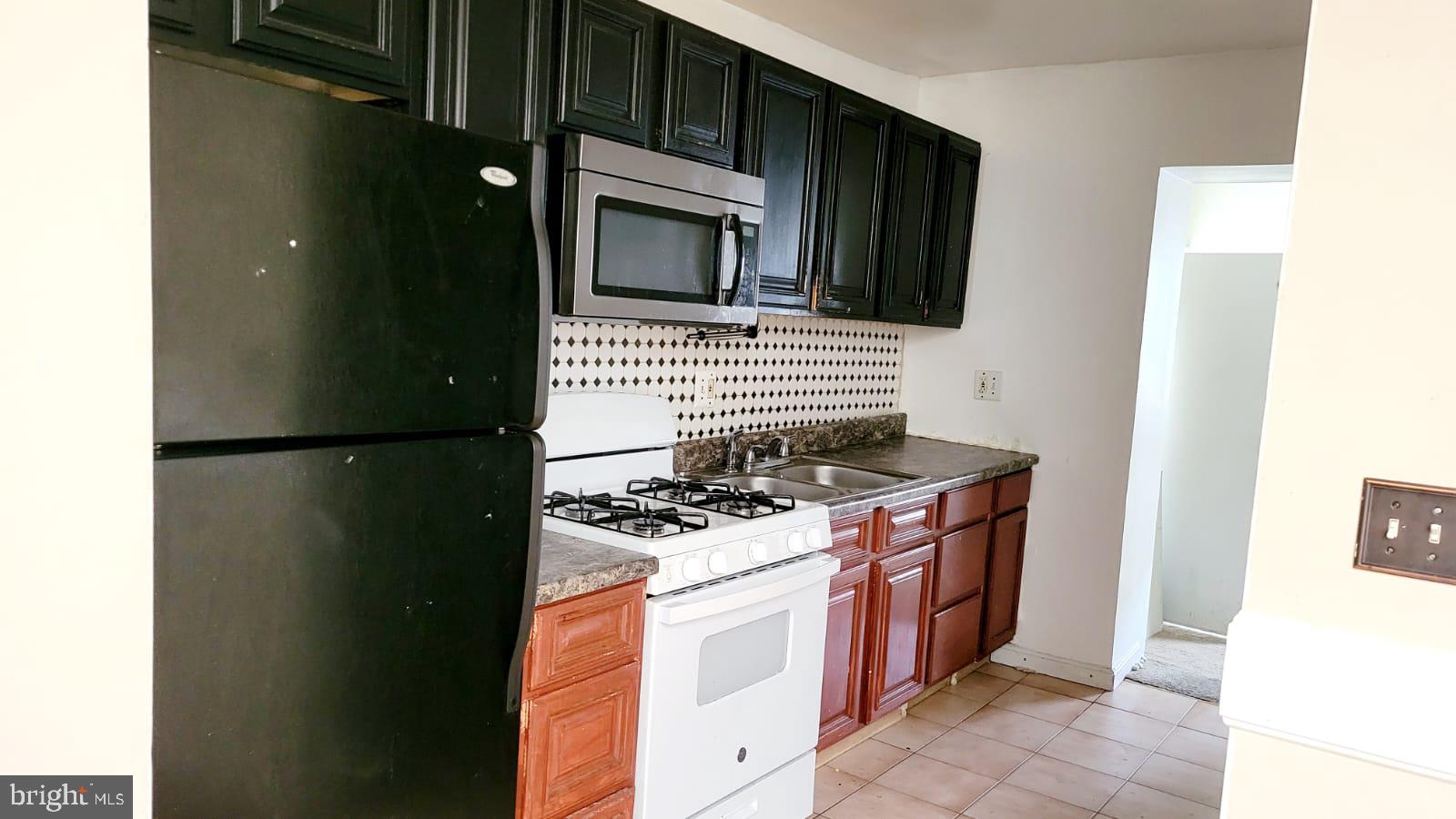 1712 Capitol Avenue Northeast Washington, DC 20002 - Photo 9 of 15 a kitchen with a stove and a microwave