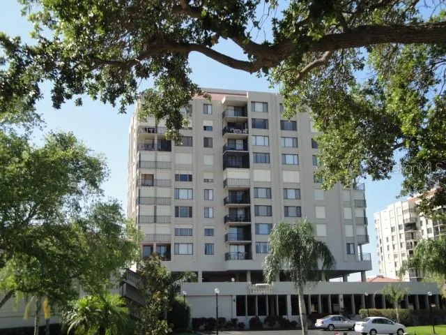 a front view of a building with a garden