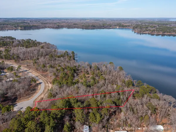an aerial view of residential house with outdoor space and lake view
