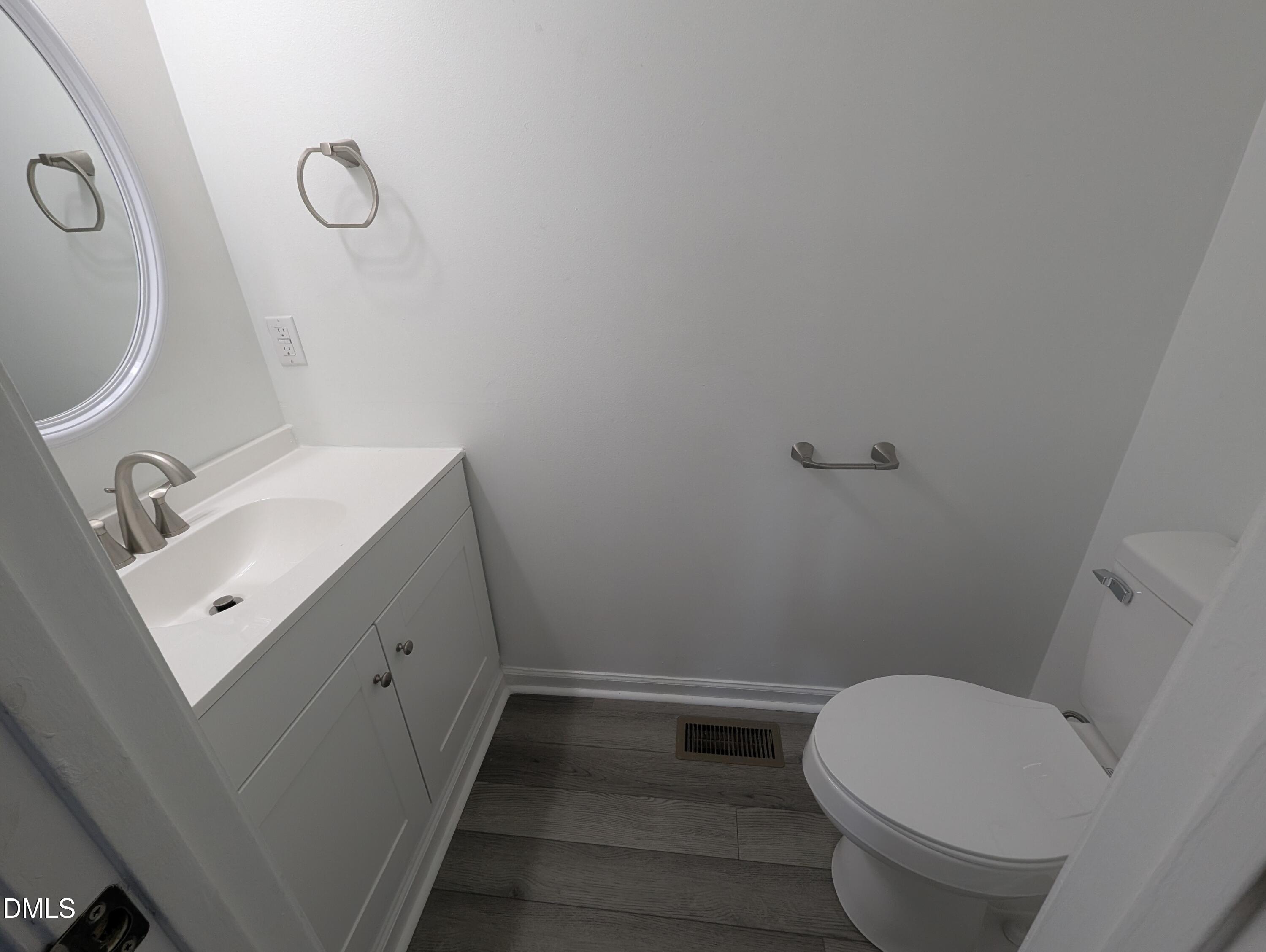 1005 Shades Place Raleigh, NC 27601 - Photo 13 of 18 a bathroom with a sink a toilet and shower