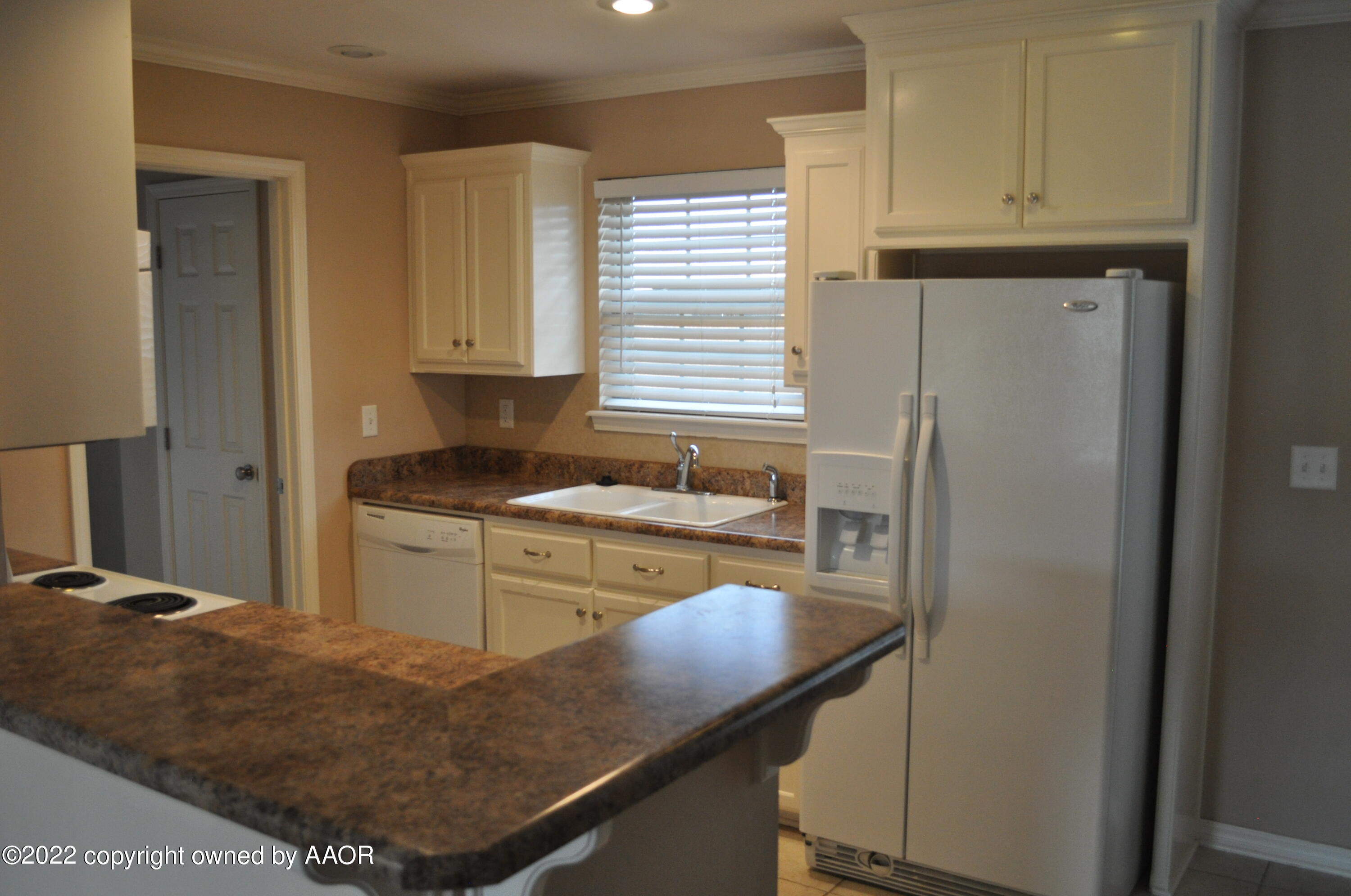 601 B 5th Street Canyon, TX 79015 - Photo 5 of 16 a kitchen with kitchen island granite countertop cabinets and refrigerator