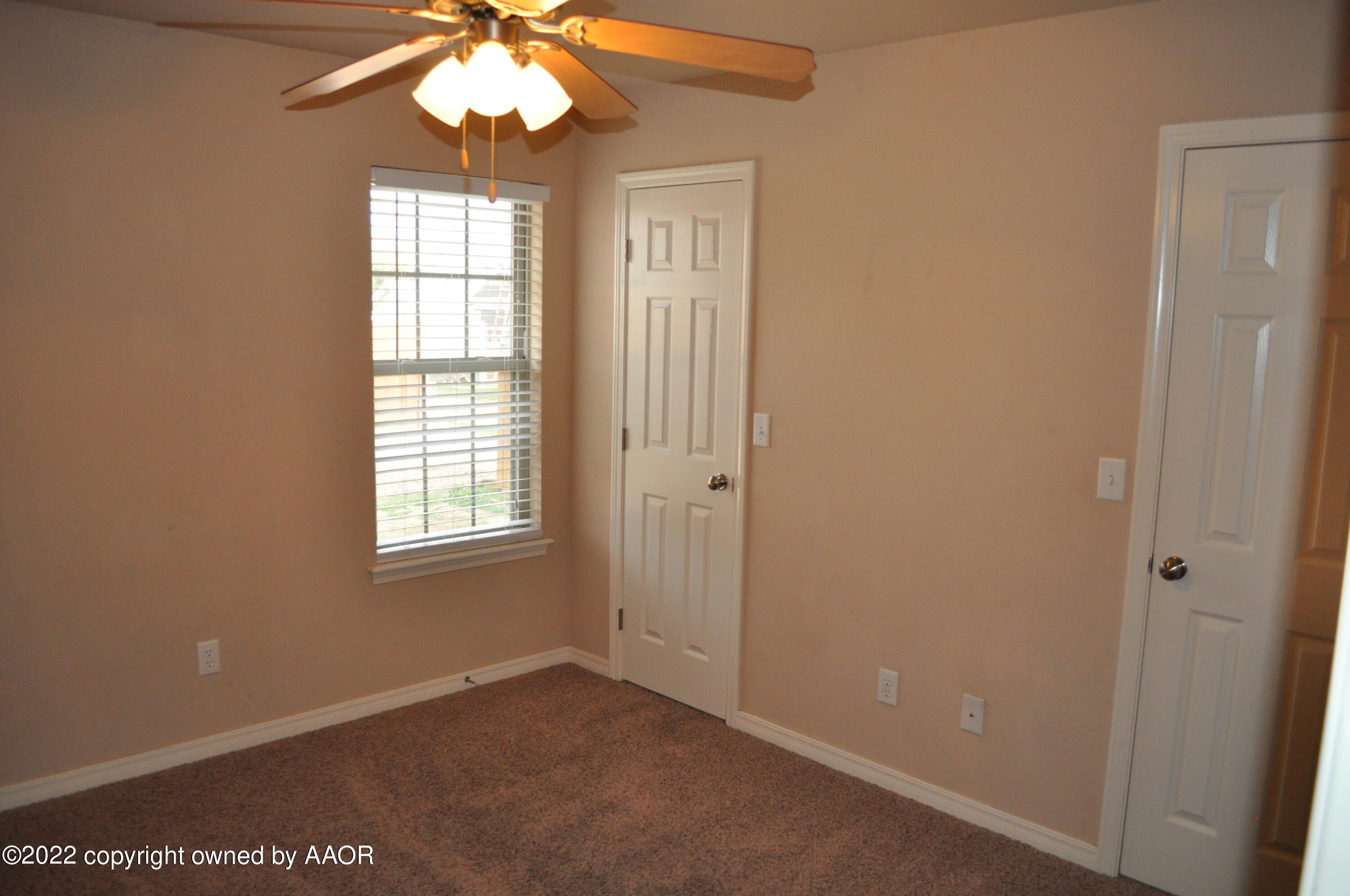 601 B 5th Street Canyon, TX 79015 - Photo 8 of 16 an empty room that has a window and a chandelier