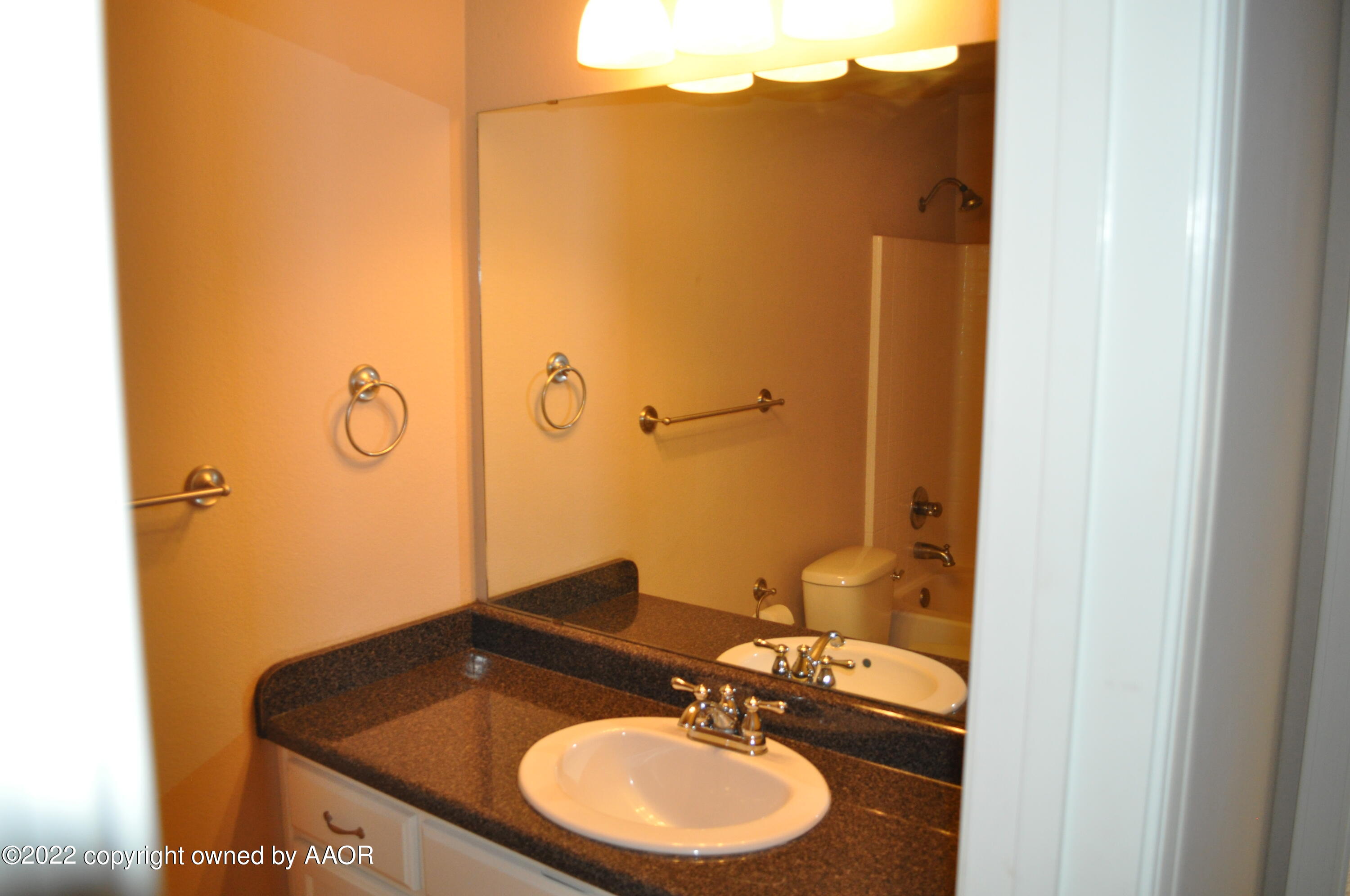601 B 5th Street Canyon, TX 79015 - Photo 10 of 16 a bathroom with a sink and a mirror