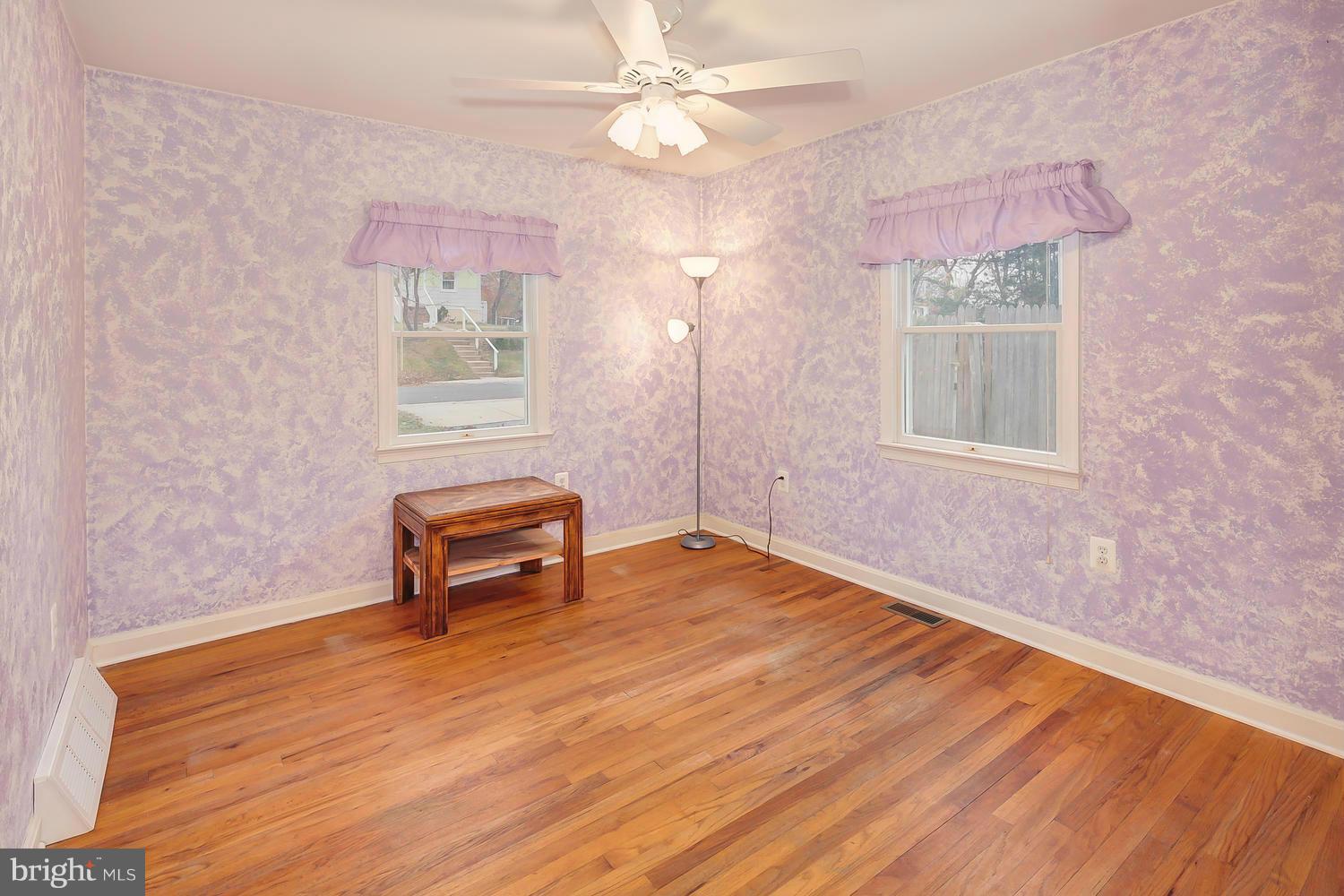 11520 Joseph Mill Road Silver Spring, MD 20906 - Photo 12 of 30 a view of an empty room with a window and wooden floor