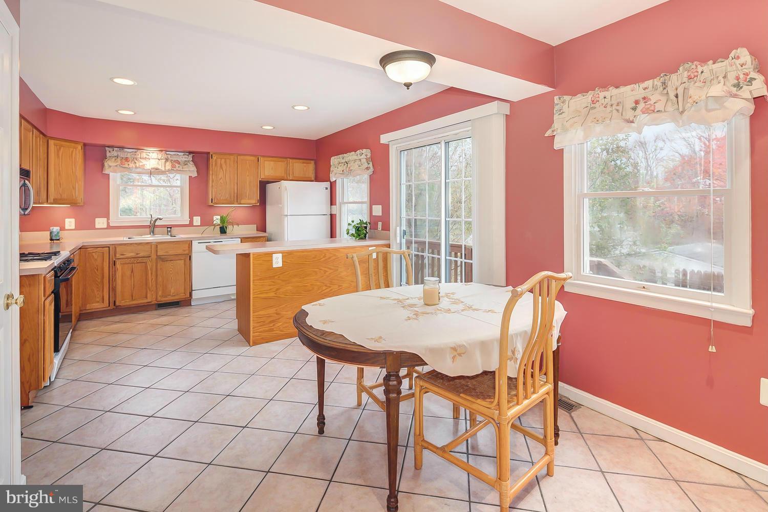 11520 Joseph Mill Road Silver Spring, MD 20906 - Photo 5 of 30 a dining room with stainless steel appliances a table and chairs
