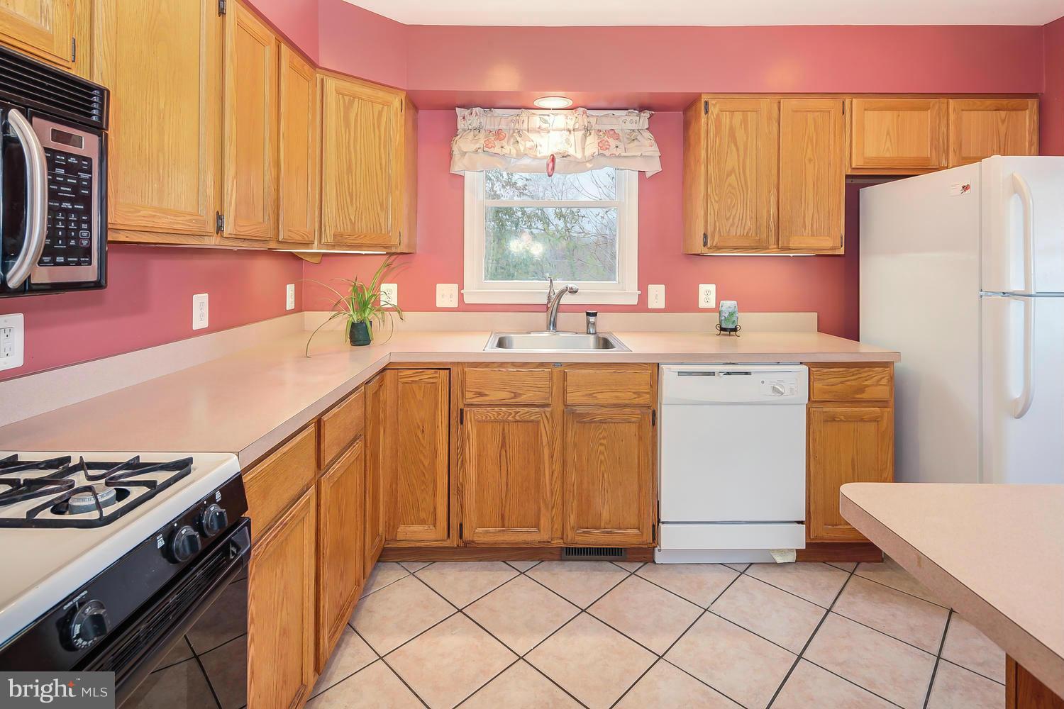 11520 Joseph Mill Road Silver Spring, MD 20906 - Photo 7 of 30 a kitchen with a sink stove and cabinets