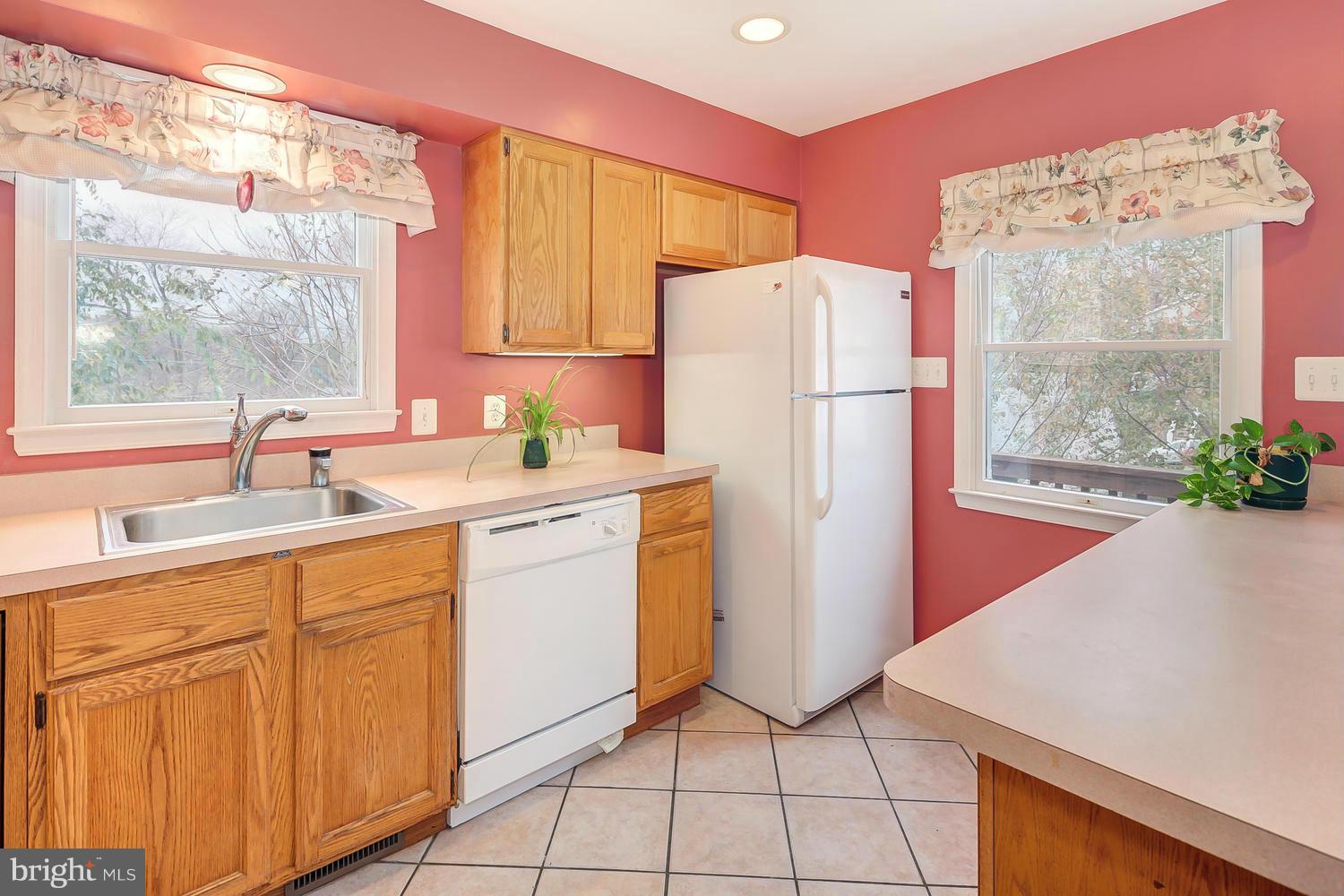 11520 Joseph Mill Road Silver Spring, MD 20906 - Photo 8 of 30 a kitchen with a sink a refrigerator and a large window