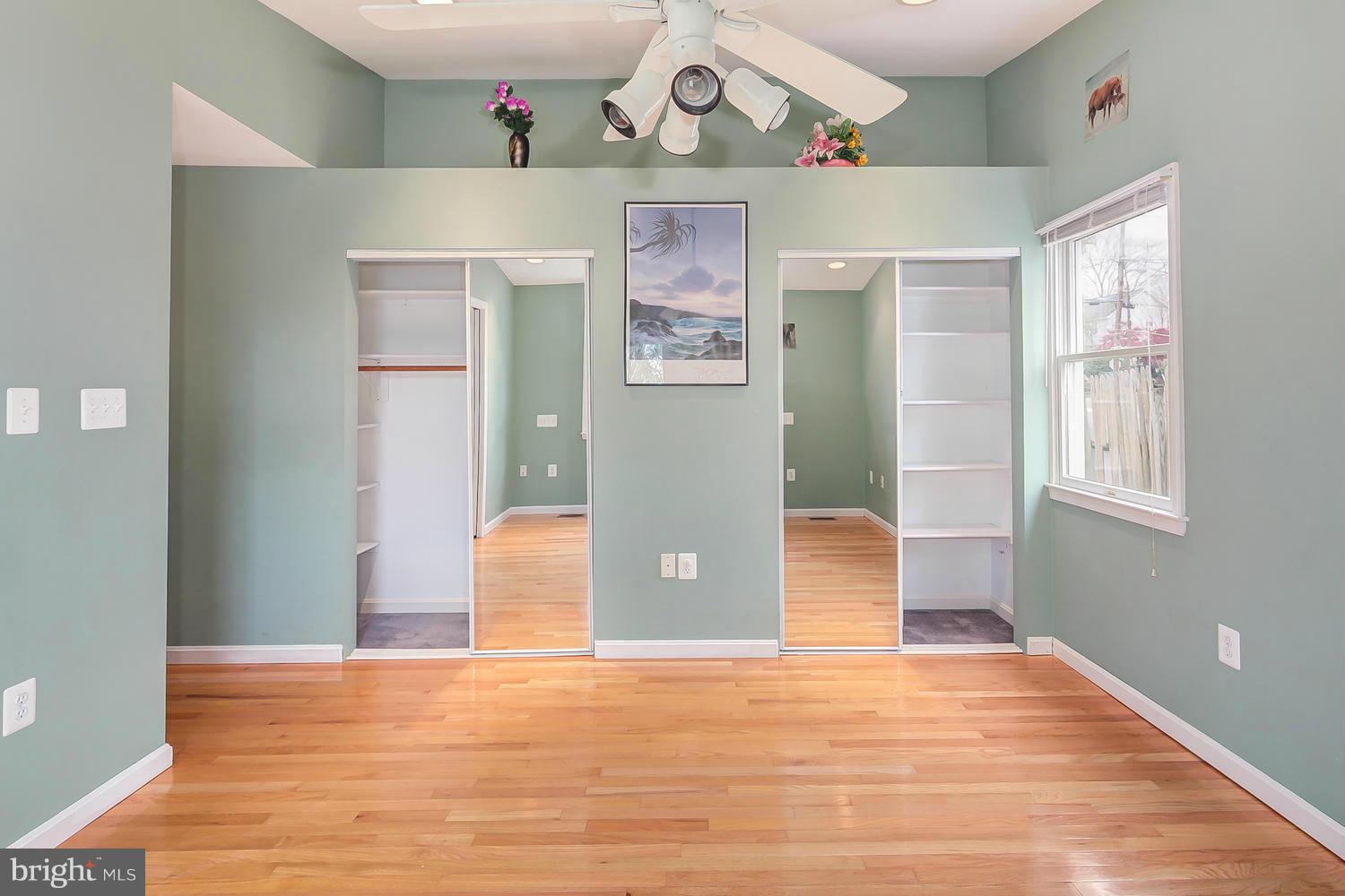 11520 Joseph Mill Road Silver Spring, MD 20906 - Photo 9 of 30 an empty room with wooden floor and windows