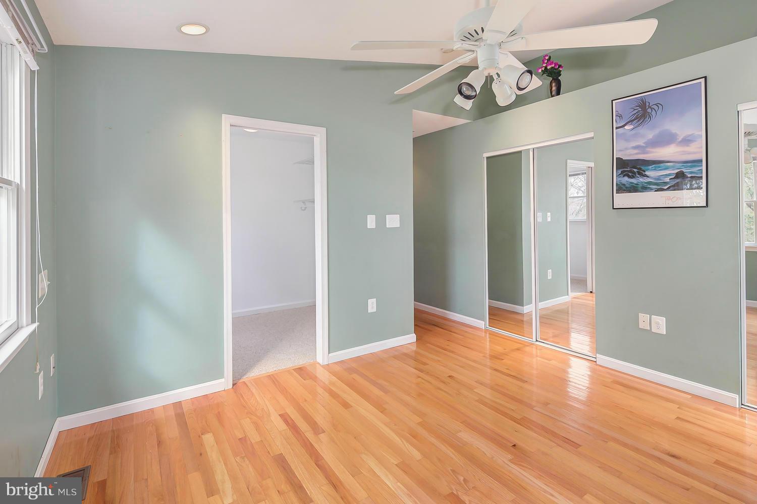11520 Joseph Mill Road Silver Spring, MD 20906 - Photo 10 of 30 a bedroom with a bed and wooden floor