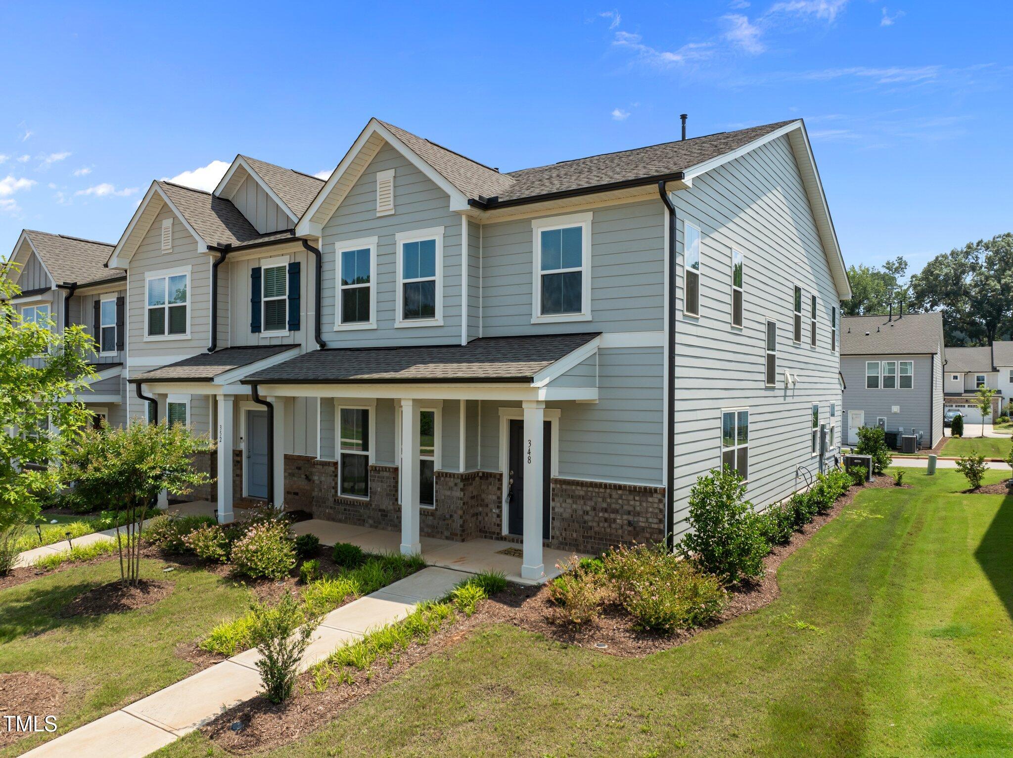 a view of a house with a yard patio and fire pit