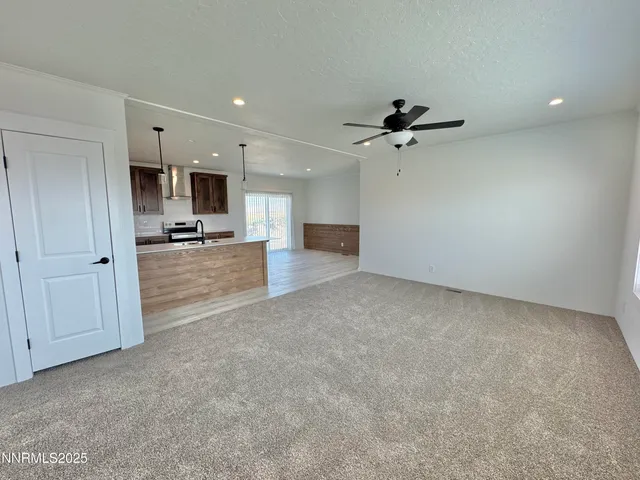 a view of a kitchen with a sink and a chandelier