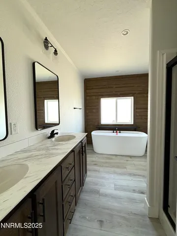 a bathroom with a double vanity sink and a mirror