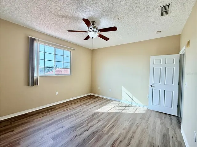 a view of a room with wooden floor