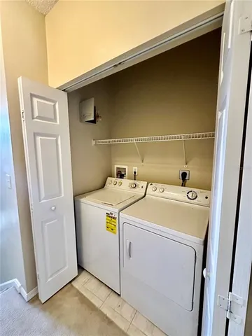 front view of a house with a yard and palm trees