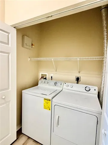 a view of a swimming pool with lawn chairs under an umbrella