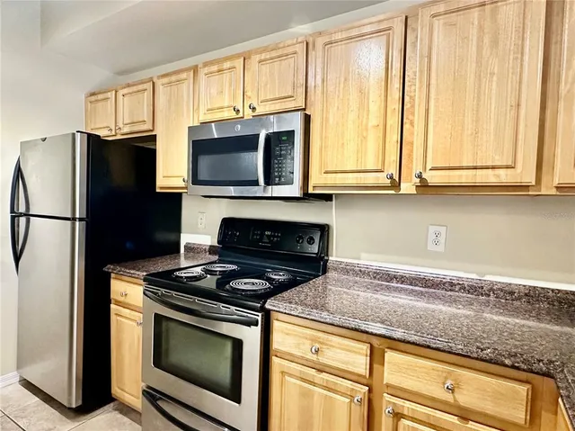 a kitchen with stainless steel appliances granite countertop a stove and a sink