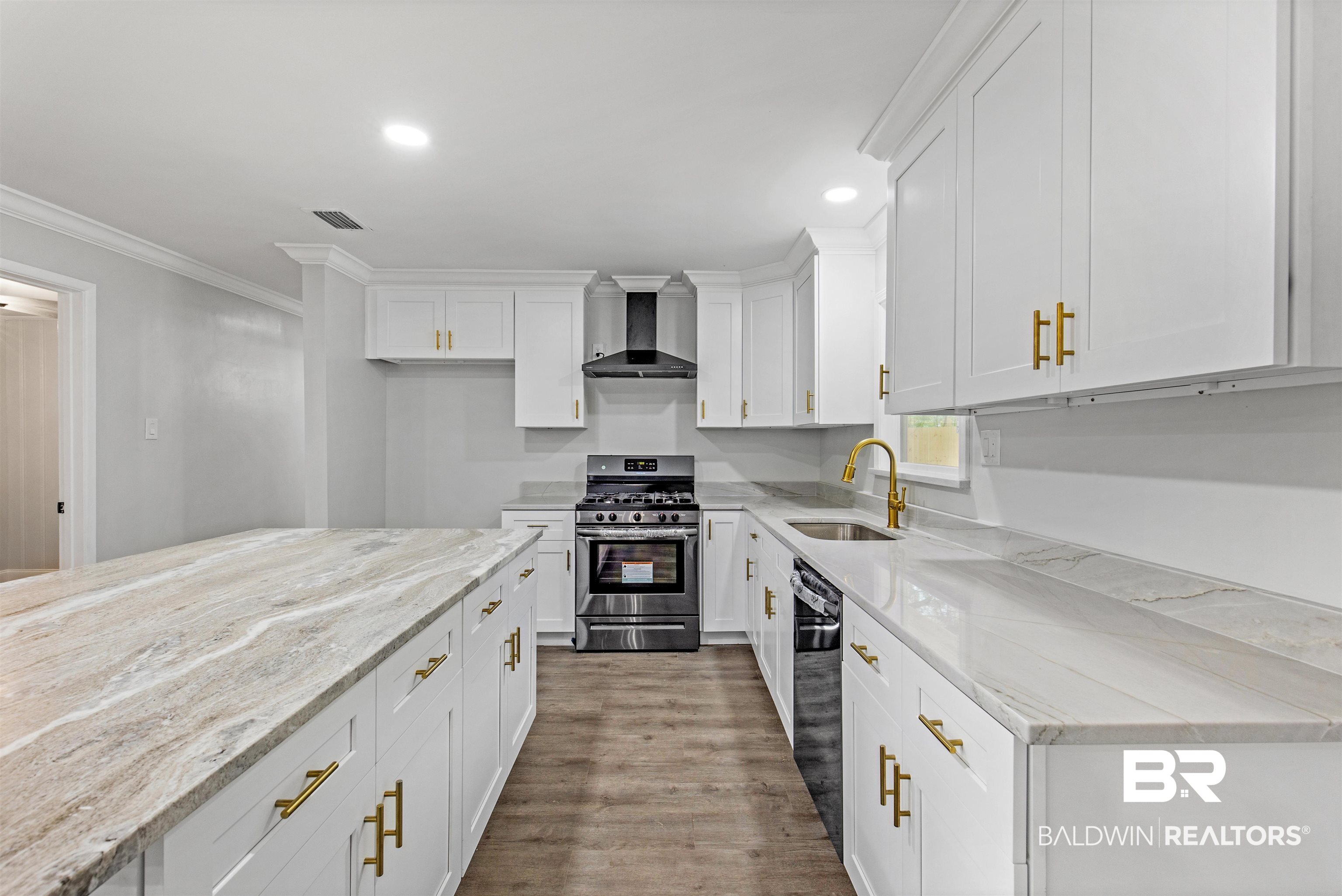 1432 South Polaris Drive Mobile, AL 36693 - Photo 7 of 27 Kitchen with stainless steel gas range oven, light stone counters, white cabinets, dark wood finished floors, and crown molding