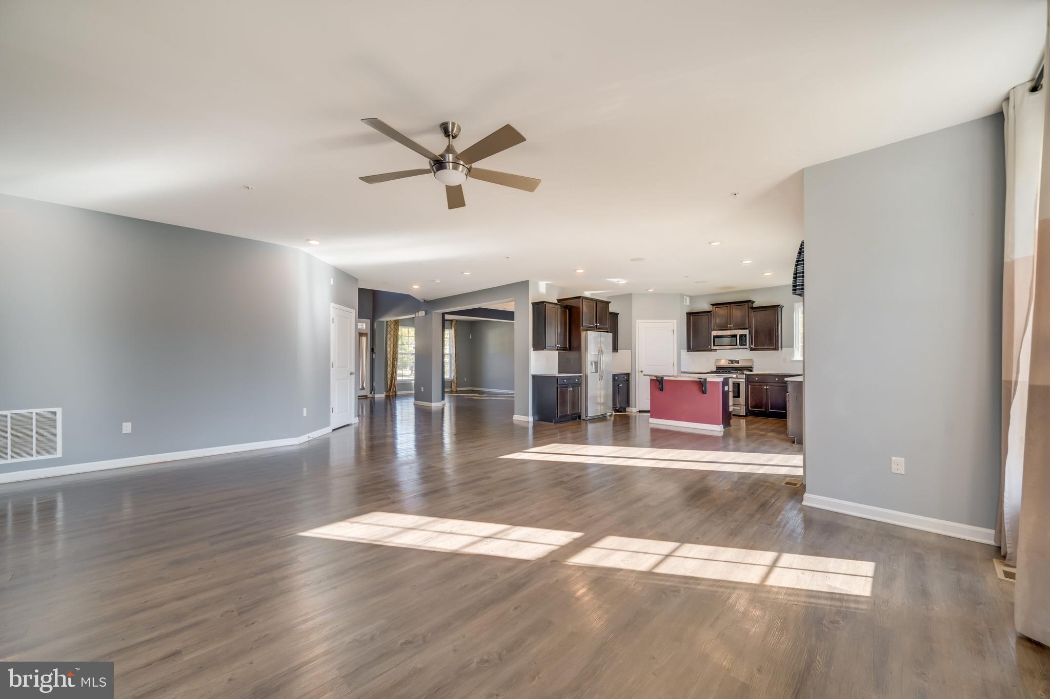 800 Naeve Court Accokeek, MD 20607 - Photo 11 of 56 a view of a livingroom with wooden floor and a ceiling fan