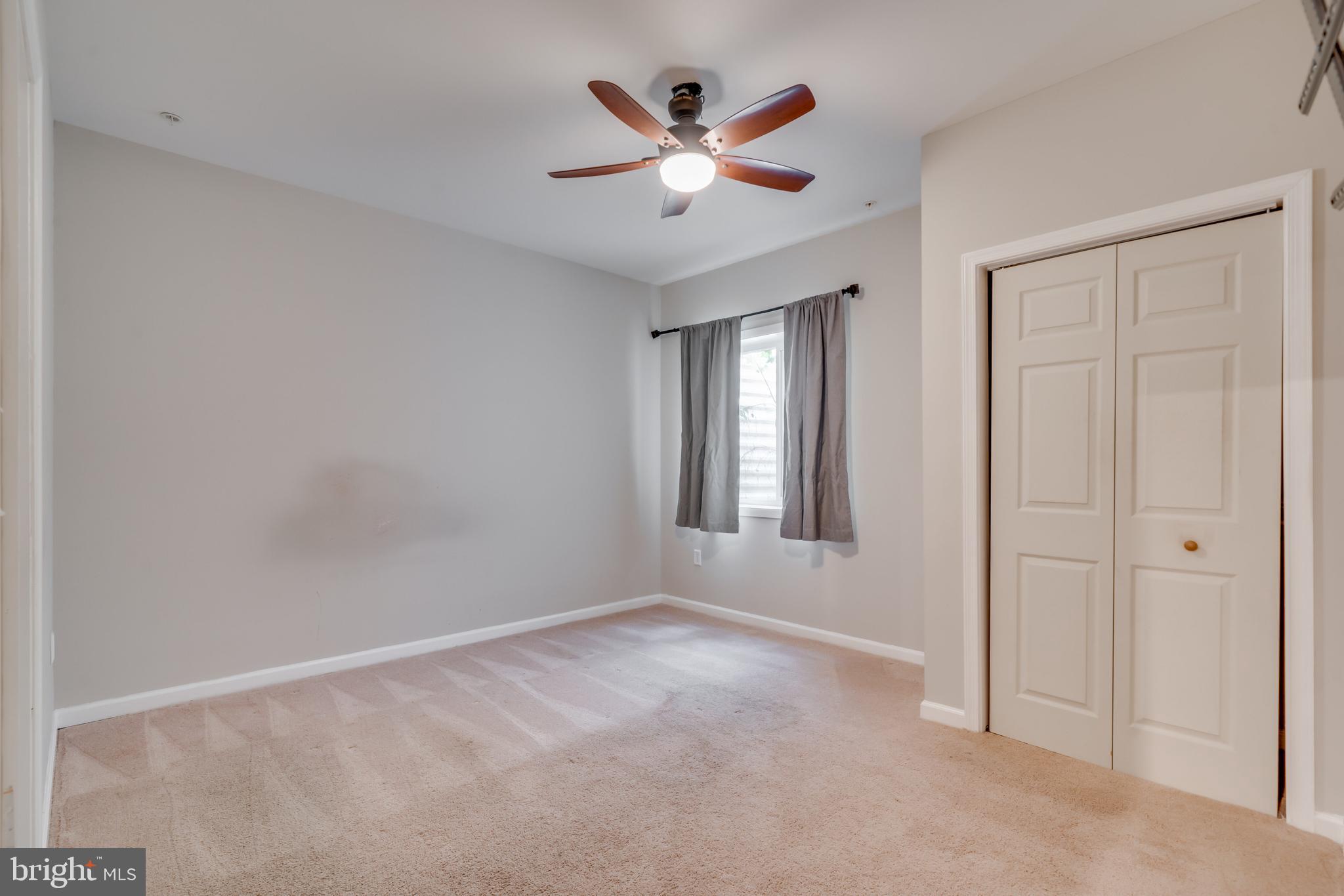 800 Naeve Court Accokeek, MD 20607 - Photo 42 of 56 an empty room with ceiling fan and window