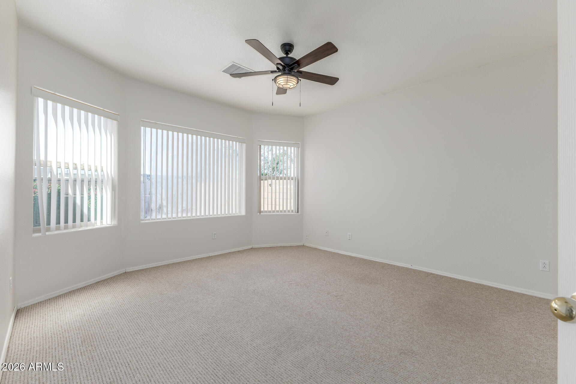 256 North 110th Street Apache Junction, AZ 85120 - Photo 11 of 27 an empty room with a window and a ceiling fan