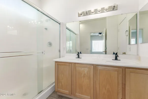 a bathroom with a double vanity sink and mirror