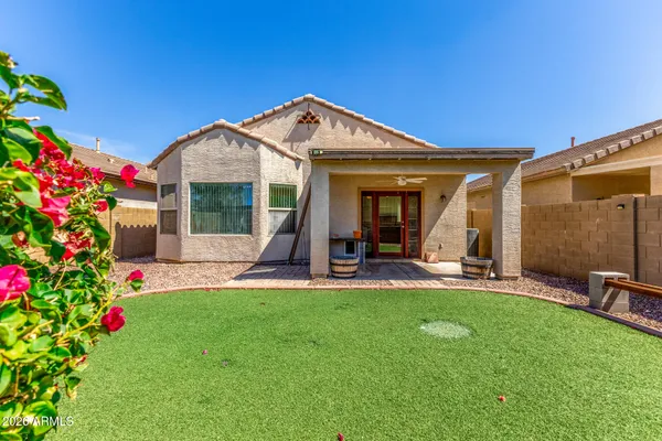 a view of a house with backyard porch and sitting area